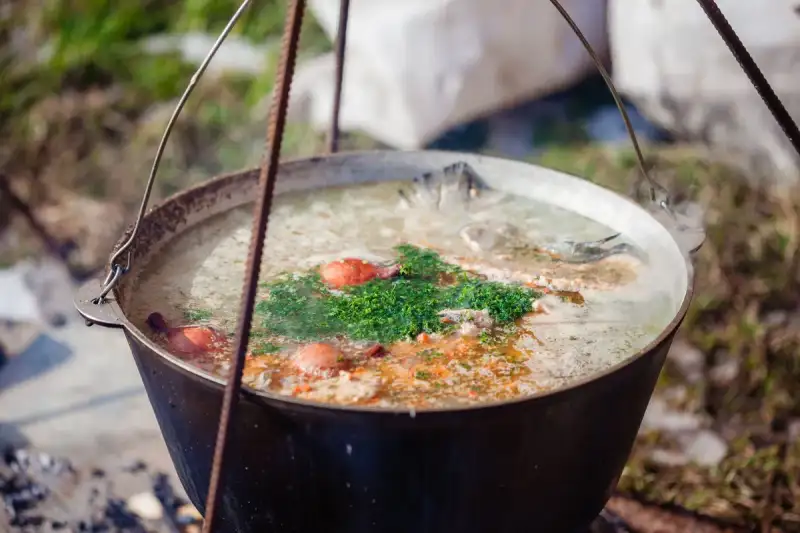A pot of mulukhiyah being cooked