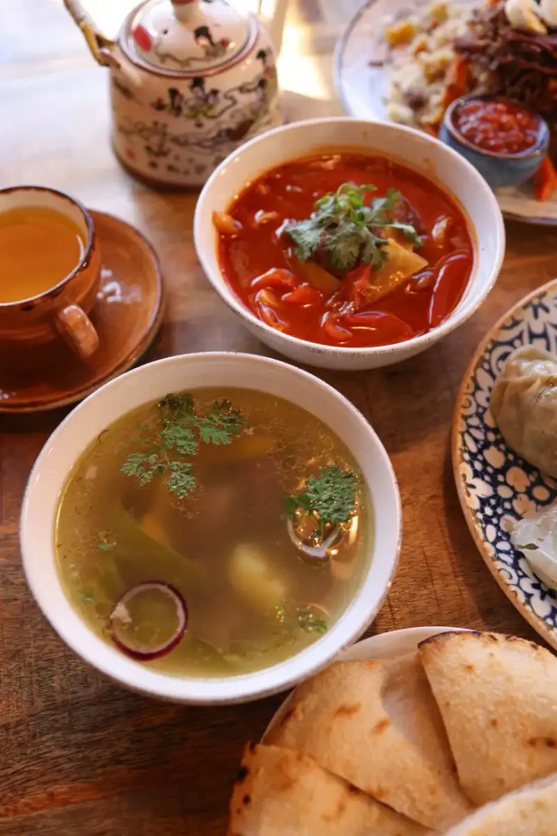A bowl of mulukhiyah being served