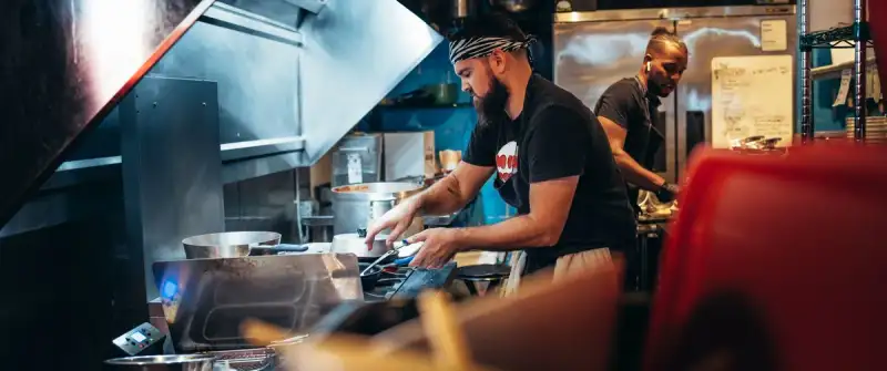 A chef expertly preparing Nihari