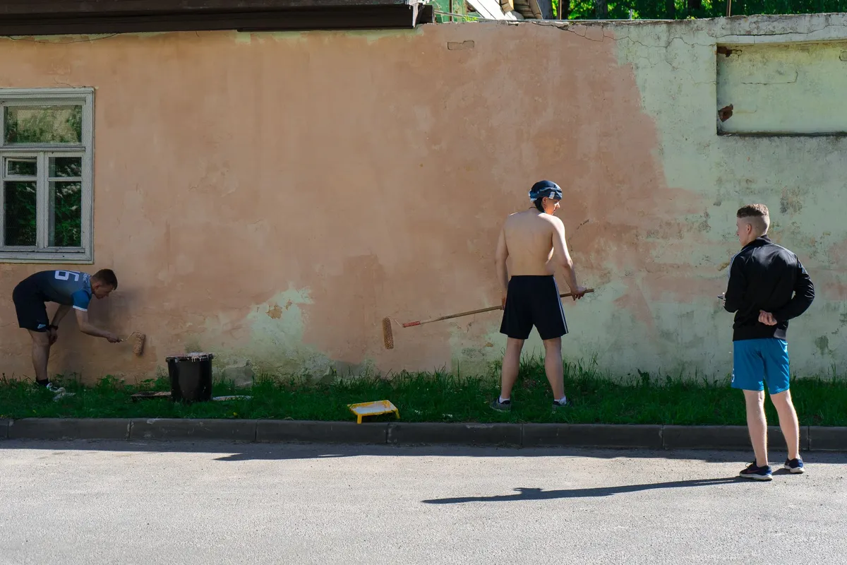 Volunteer painting wall