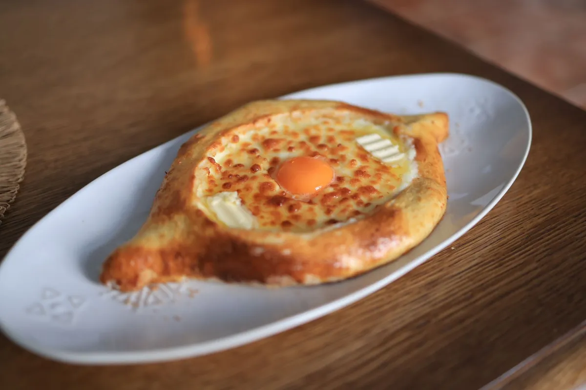 Adjarian khachapuri boat with egg yolk and butter