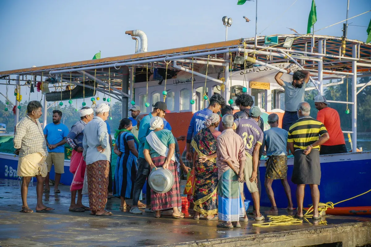 A bustling coastal market in Kerala with fresh seafood and spices
