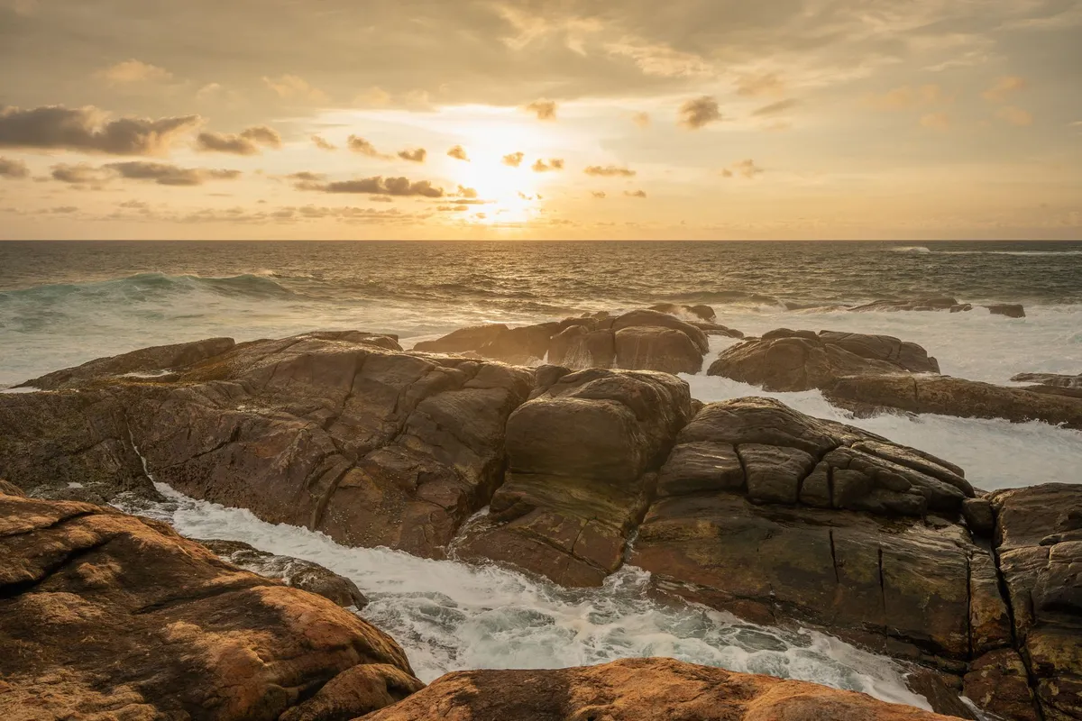 A sunset over the Indian Ocean with a traditional South Indian meal in the foreground