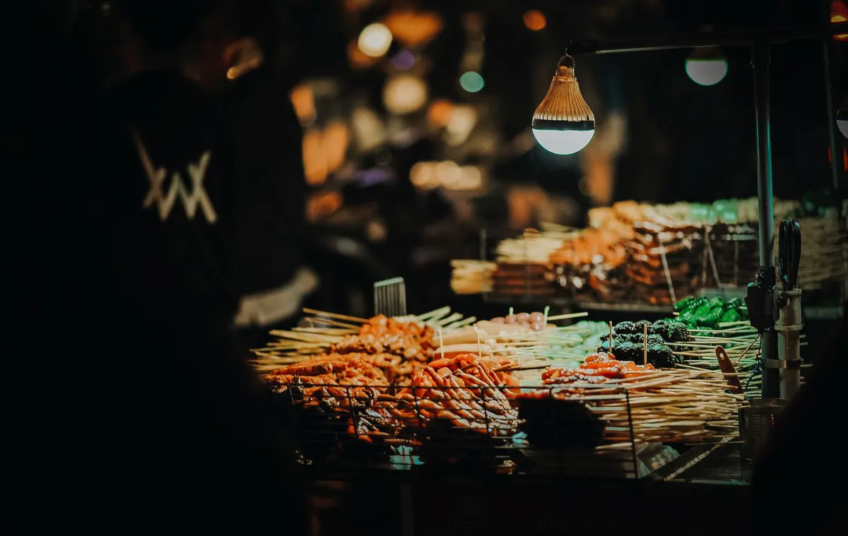 A vibrant night market in Marrakech with lanterns and food stalls