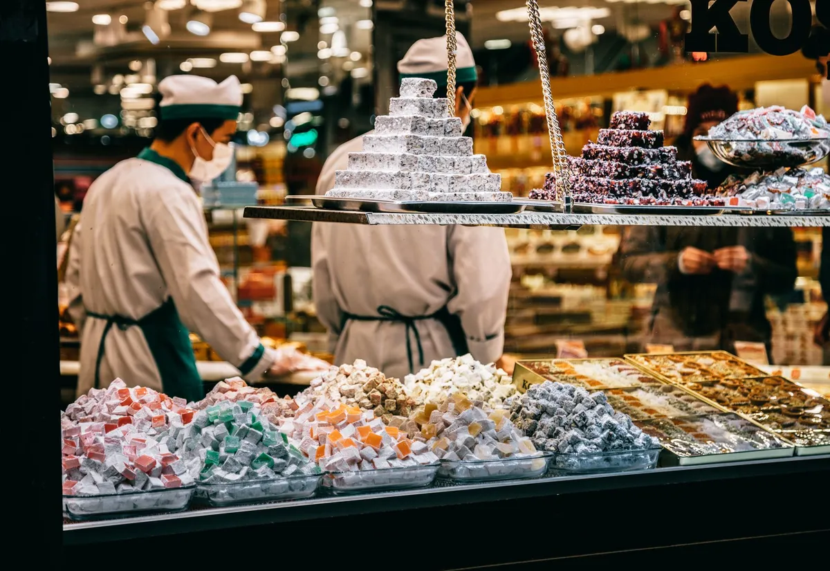 A vendor selling Turkish delight and spices at a stall in Istanbul's Spice Bazaar