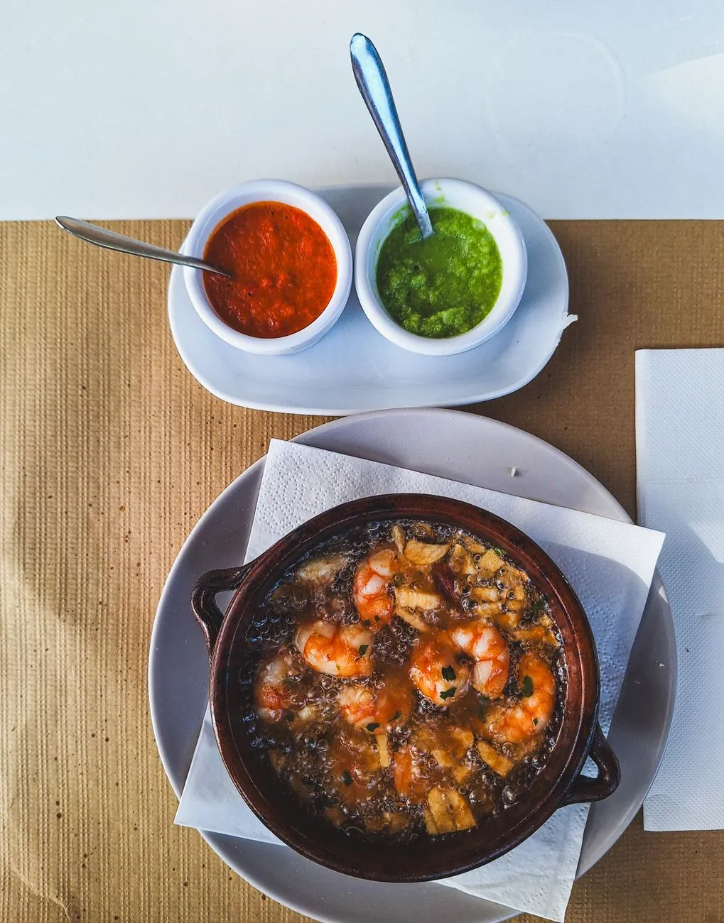 Freshly prepared garlic shrimp in a clay dish
