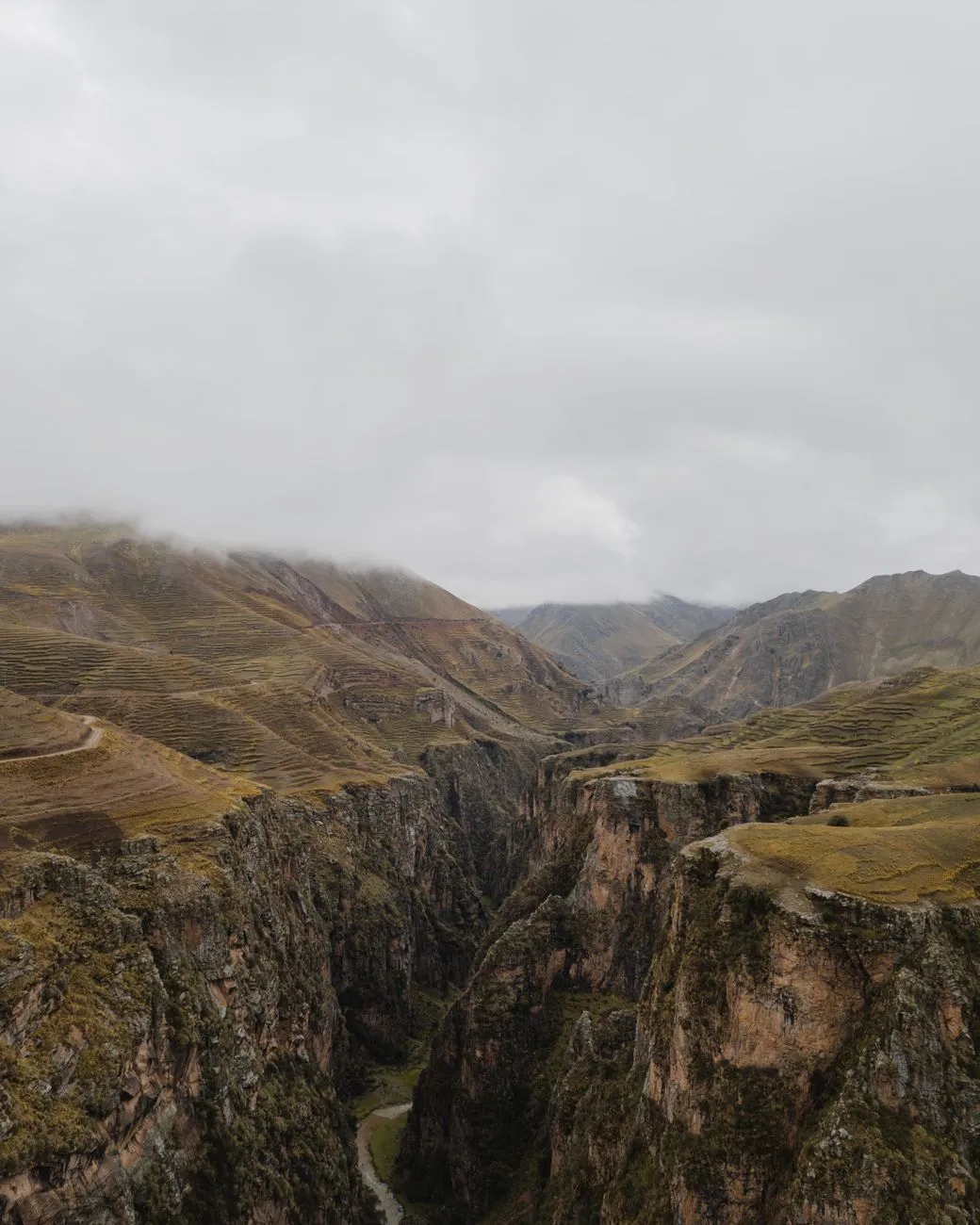 Misty canyon walls framing a narrow river