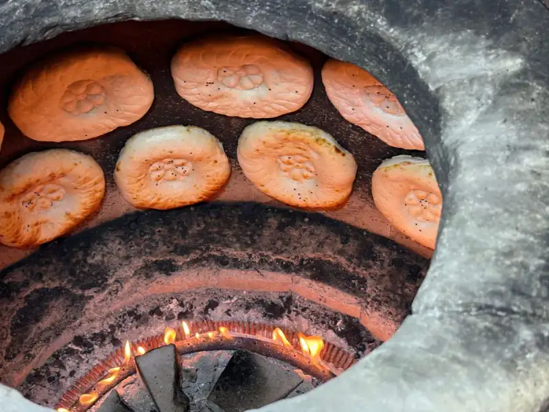 Sheermal being baked in a tandoor