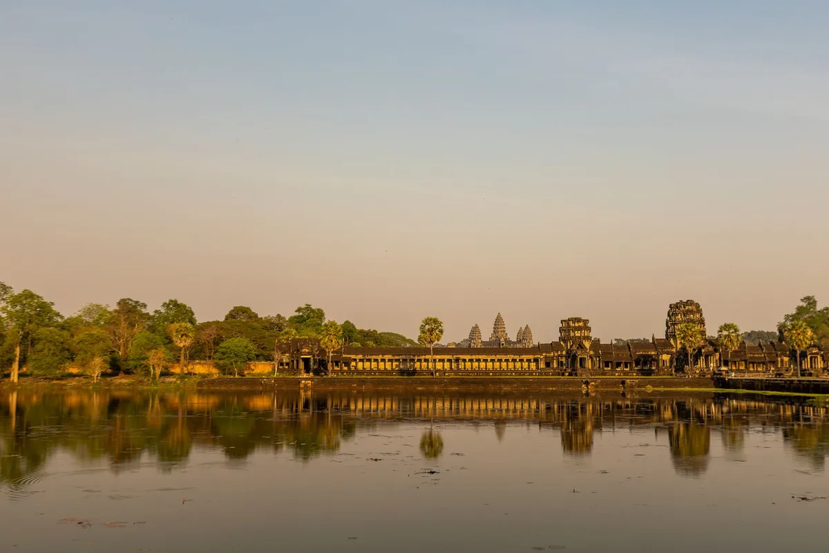 Sunset over Angkor Wat with reflection in a lotus pond