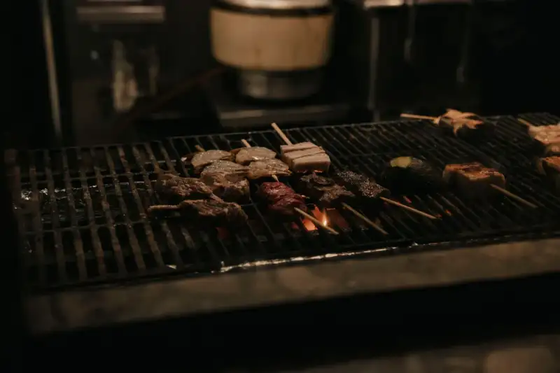 Spicy cumin skewers being grilled