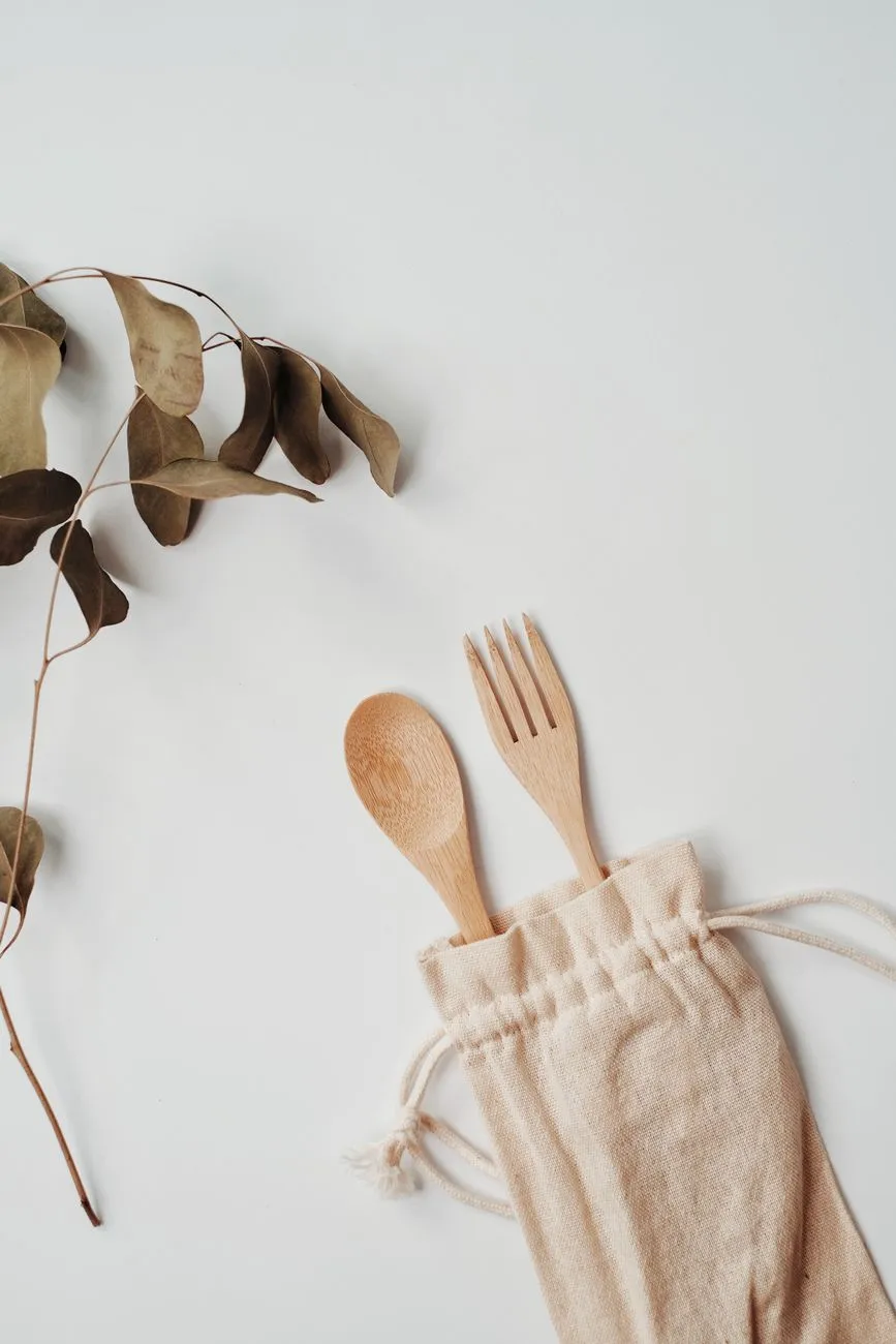 A zero-waste travel kit with reusable bottles, bamboo utensils, and a solar charger