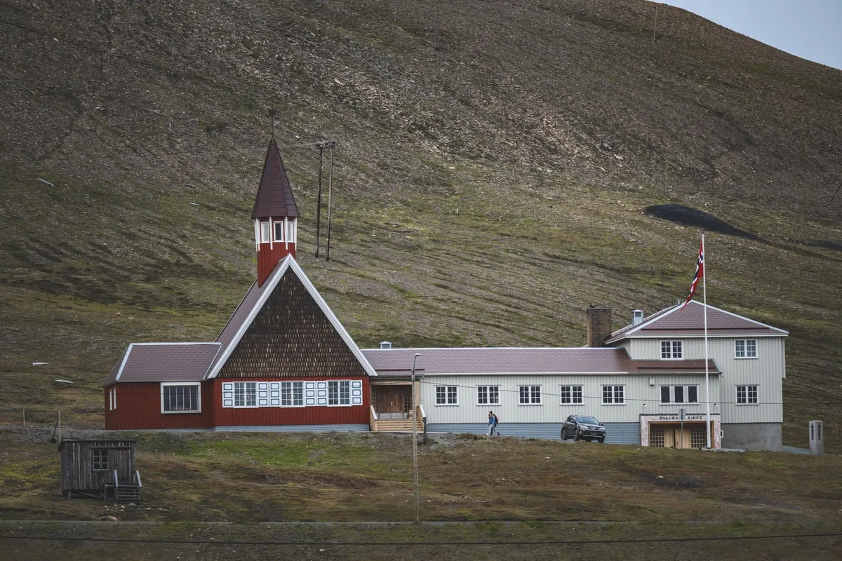 Longyearbyen town with colorful houses and snowy mountains
