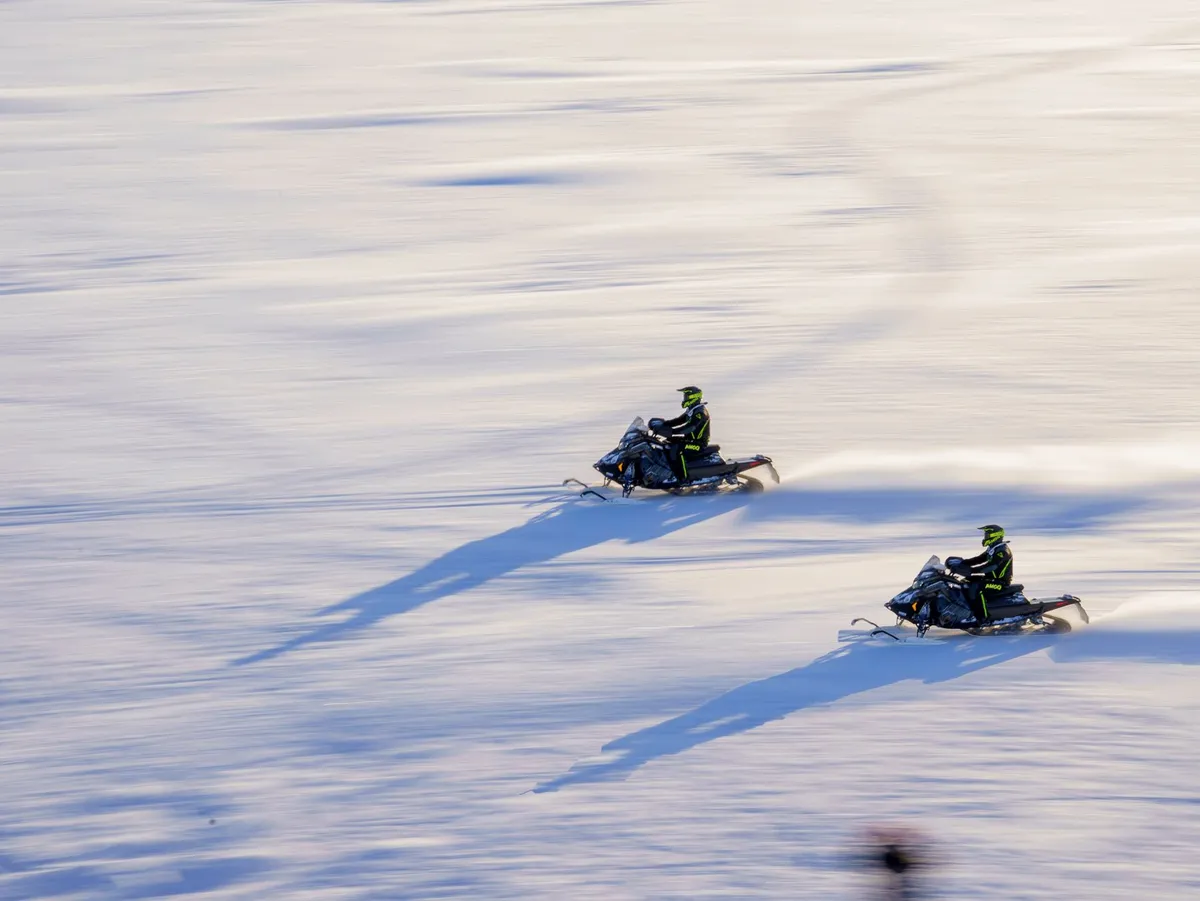 Snowmobile parked on frozen fjord