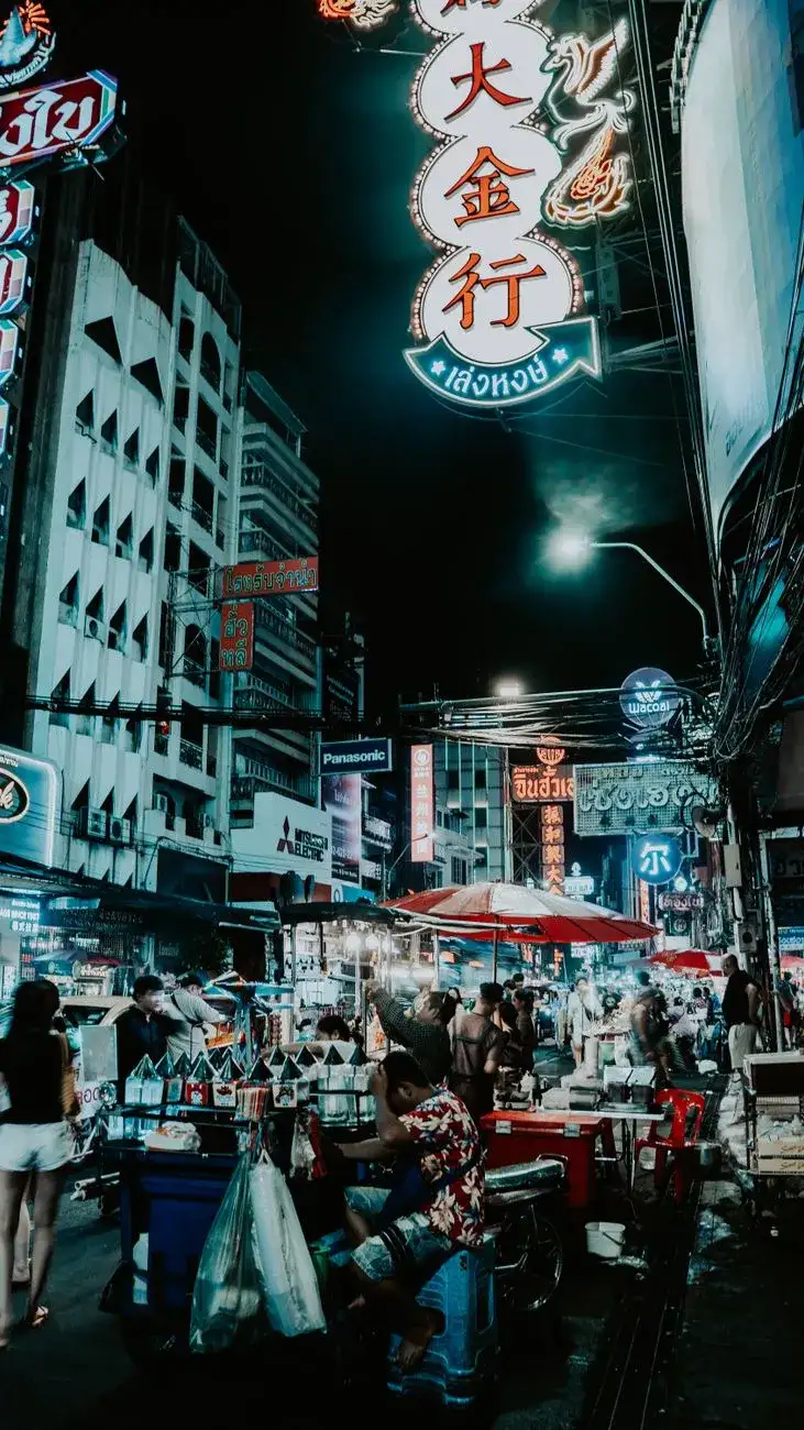 A bustling Bangkok street food market at night