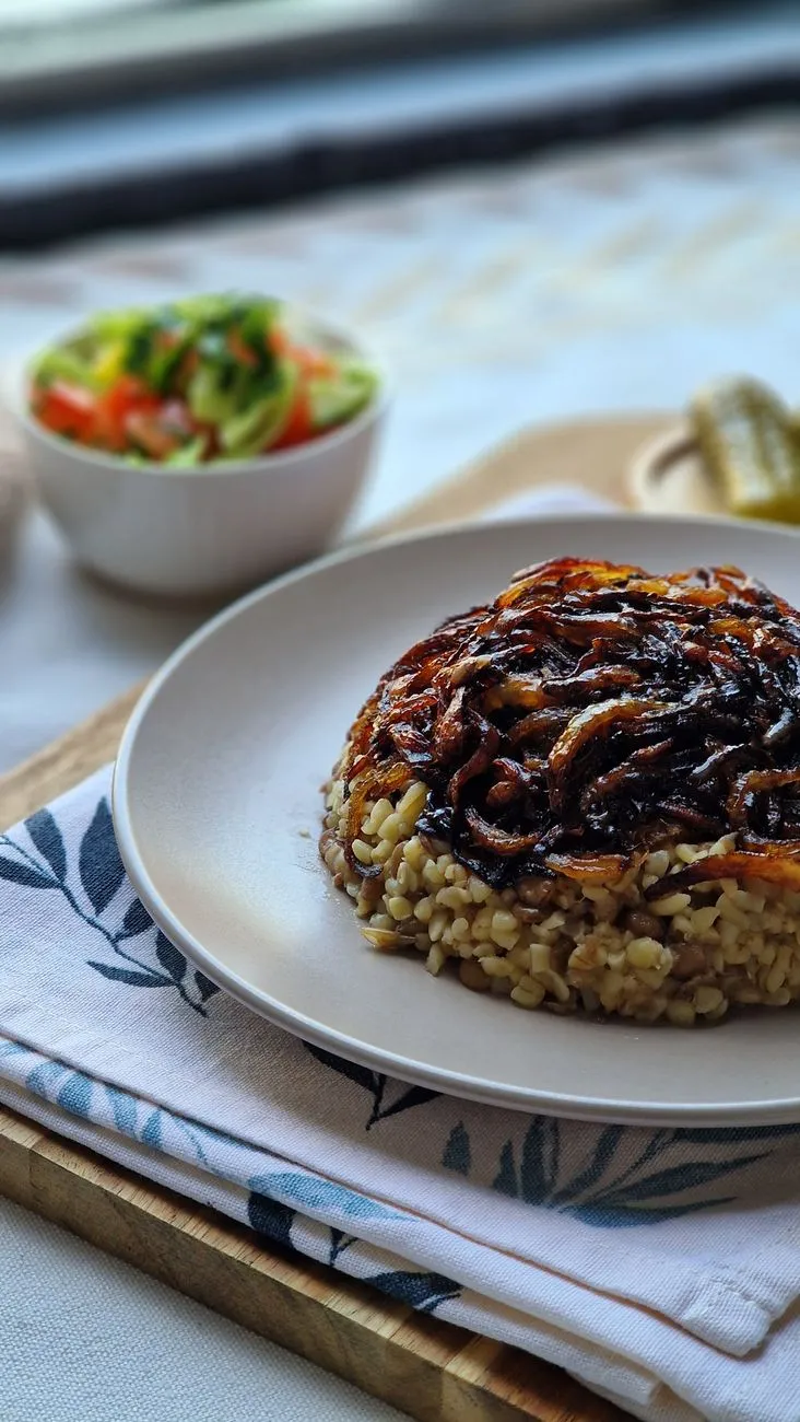 A close up shot of freshly prepared Koshari with chickpeas and crispy onions