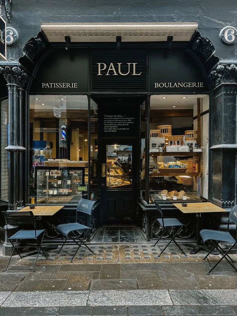 A beautifully arranged display of French pastries in a bakery window