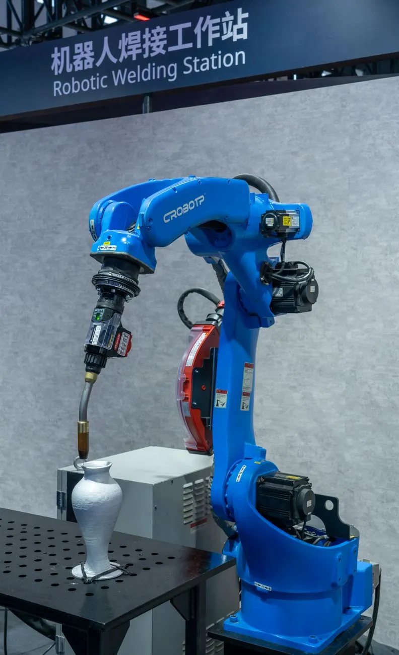 Robotic arm assembling a battery pack in a factory