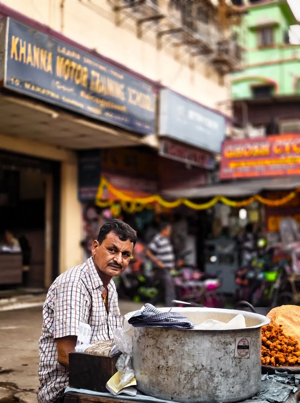 A colorful display of Indian street snacks on a cart