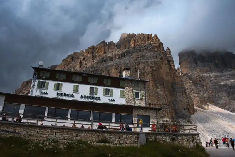 Rifugio interior with hikers enjoying a meal