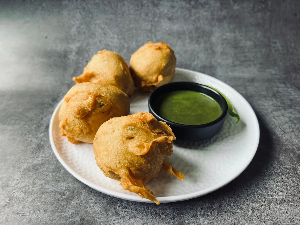 A vibrant plate of Mumbai's famous Vada Pav served on the street