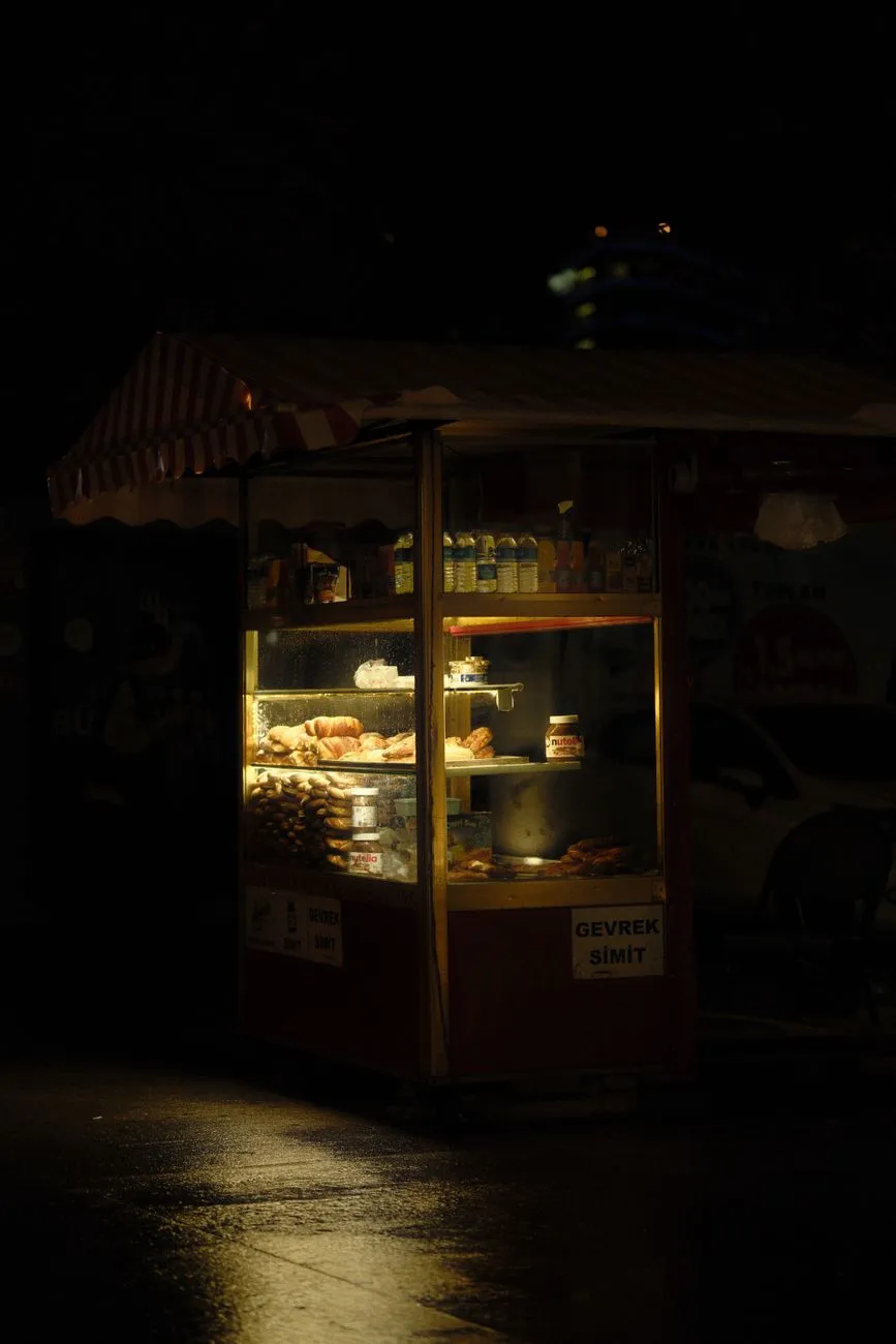 A busy street scene with vendors preparing Indian street food