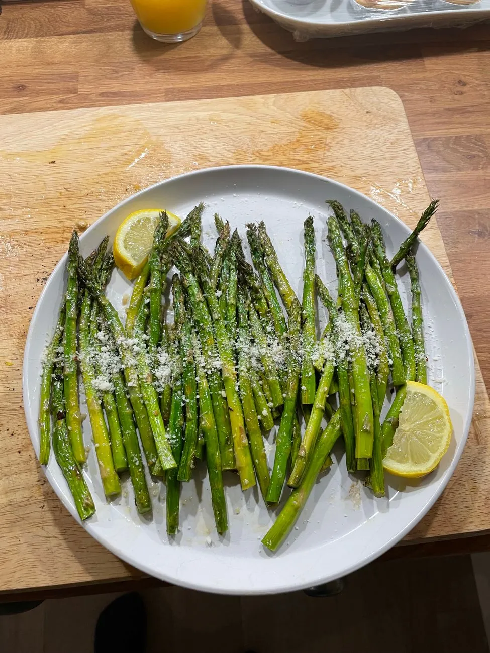 A minimalist plate of grilled asparagus with a drizzle of olive oil and flaky salt, demonstrating the elegance of subtle umami