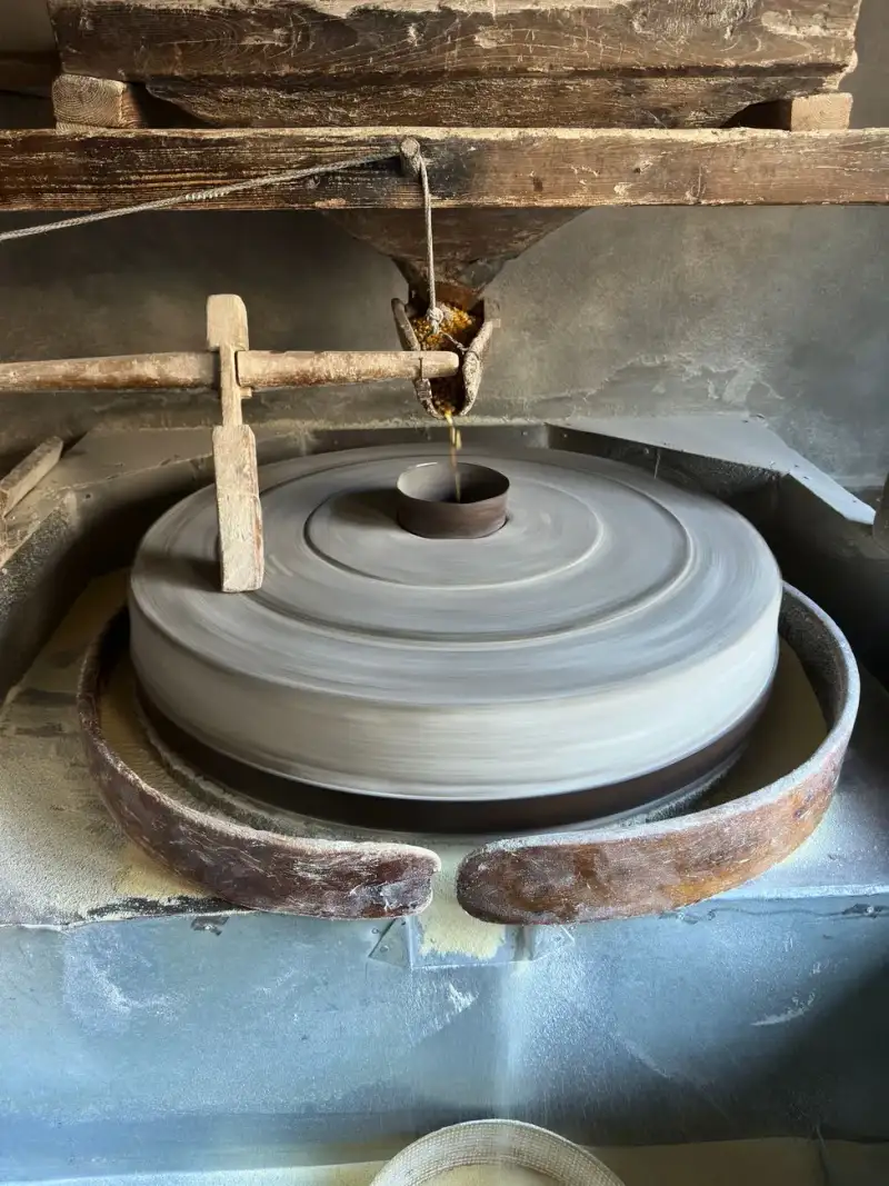Ancient stone grinding wheel for flour production in a rustic setting