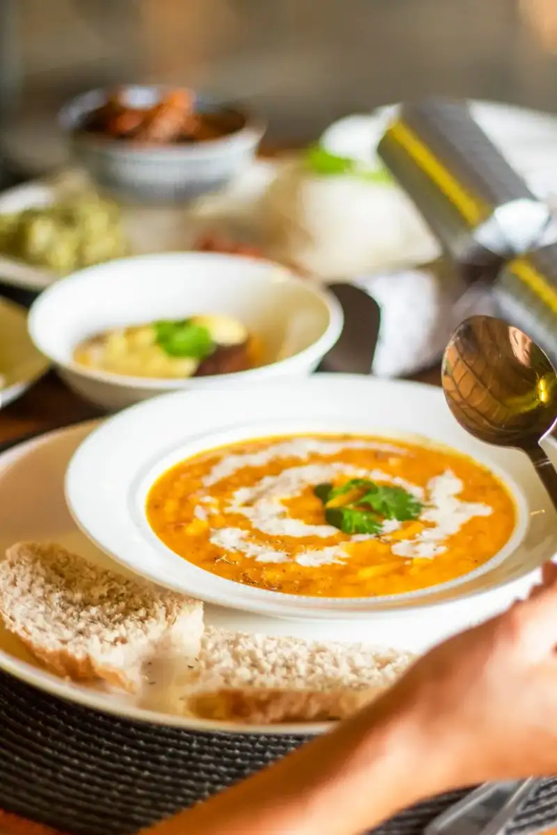 Vibrant bowl of red lentil soup with mint garnish