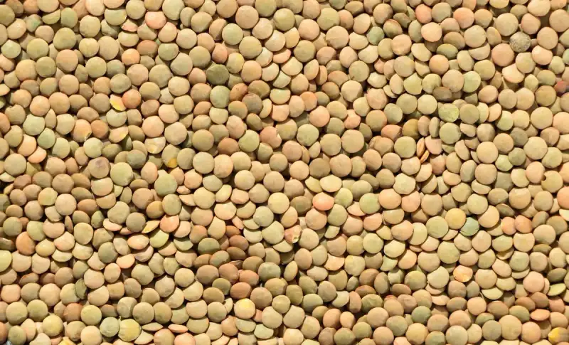 Ingredients for red lentil soup laid out on a wooden table