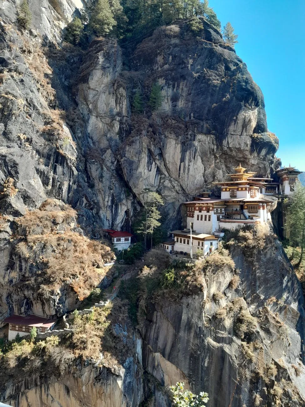 Hiker viewing Tiger's Nest monastery from mountain trail