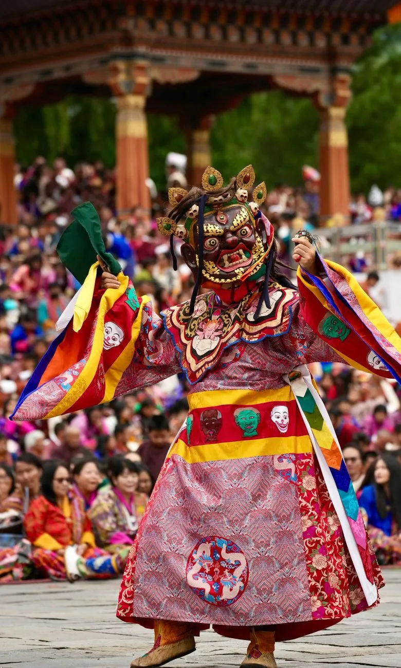 Bhutanese locals in traditional gho and kira clothing at festival