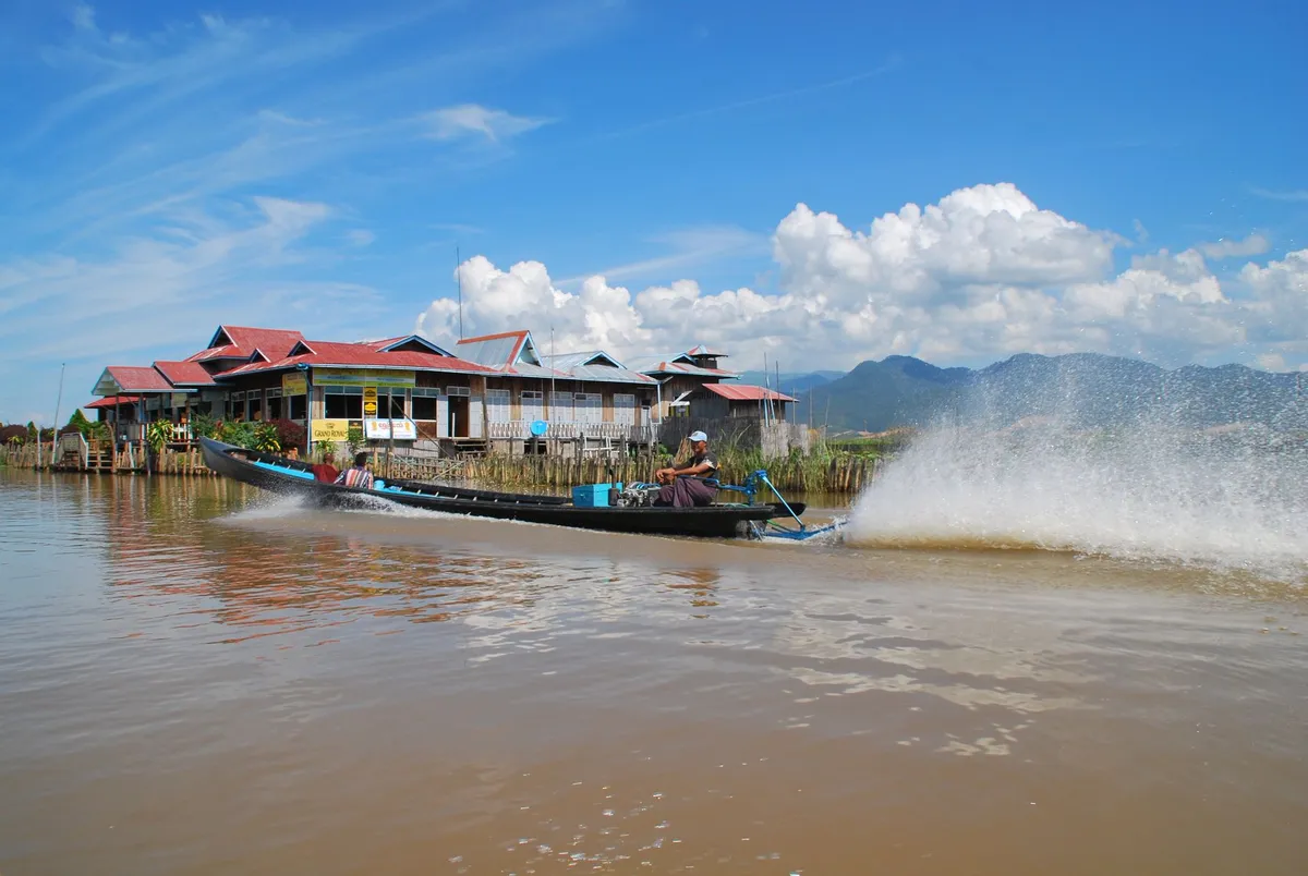 Boats navigating the narrow canals of a floating village