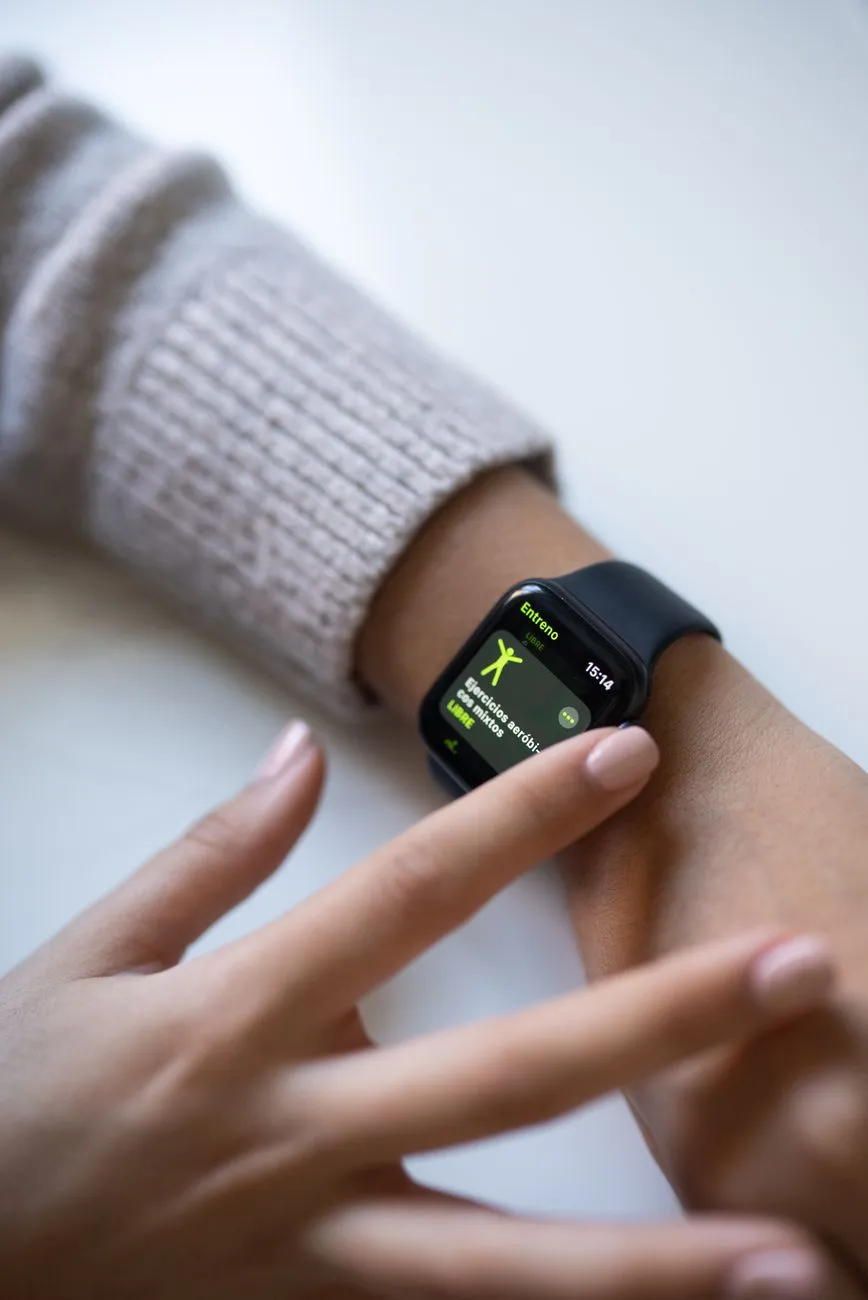 Close-up of a smartwatch displaying health metrics with a subtle holographic interface overlay