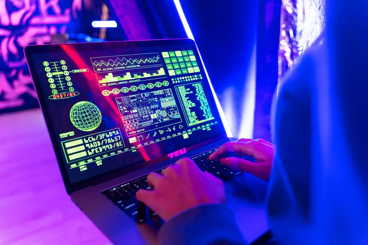 A developer working on a laptop with a holographic interface showing IoB security protocols