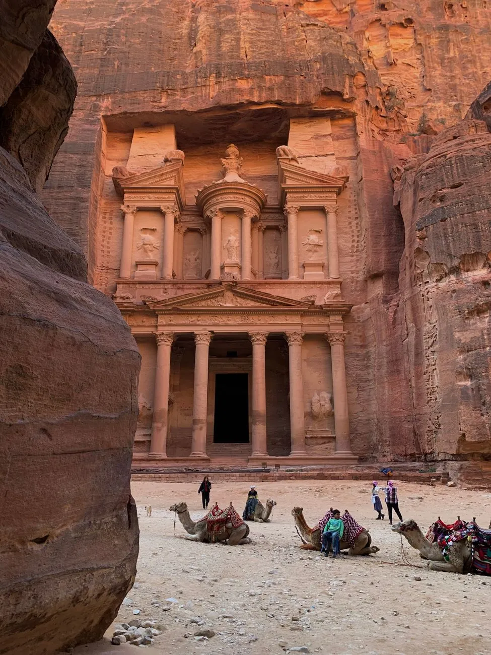Tourists exploring Petra's ancient streets during sunrise