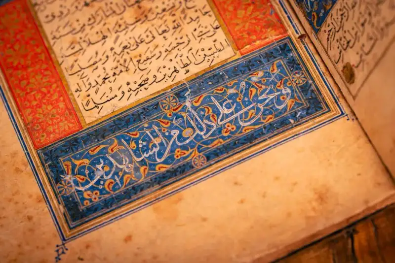Elaborate 16th-century Italian manuscript open to a richly illuminated page, a small silver filigree pomander resting on the spine, diffused light from a renaissance window, soft focus on textures