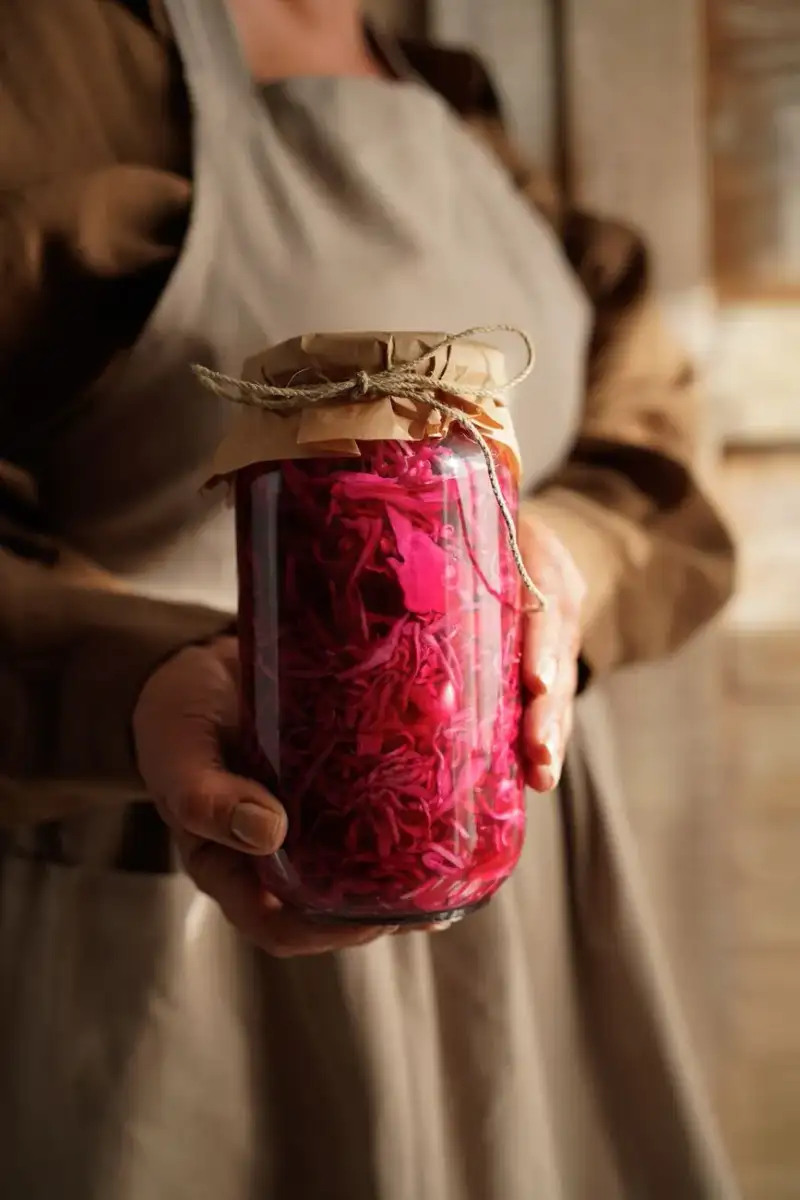 A rustic table setting with fermented sauerkraut, whole grain bread, and raw lentils