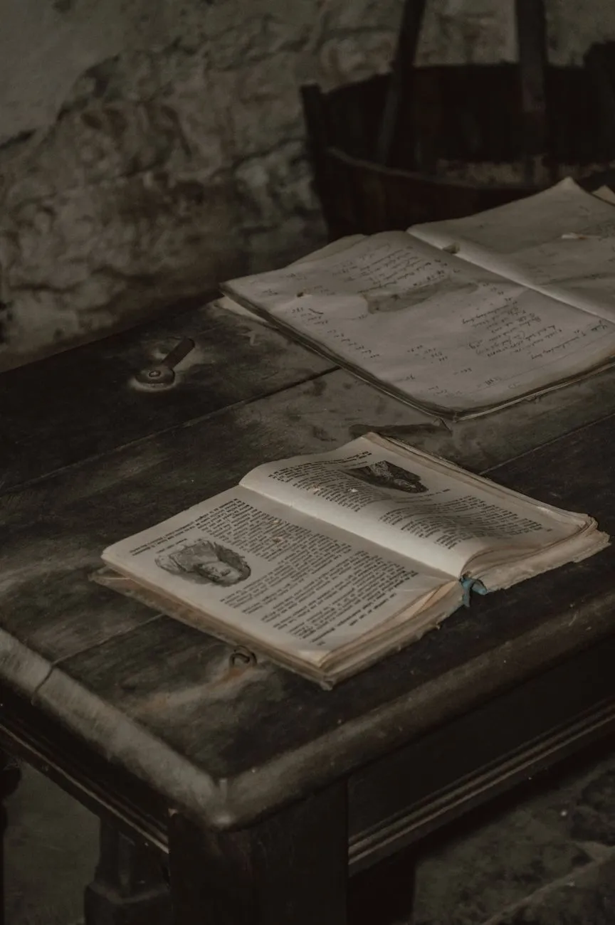 Stacks of old leather bound books in a dark room