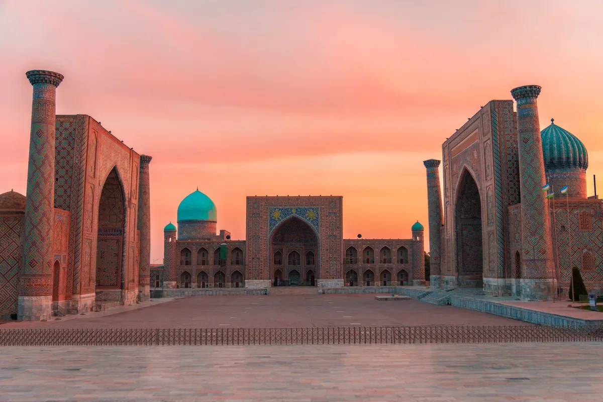Registan Square at sunset with golden domes and intricate tilework