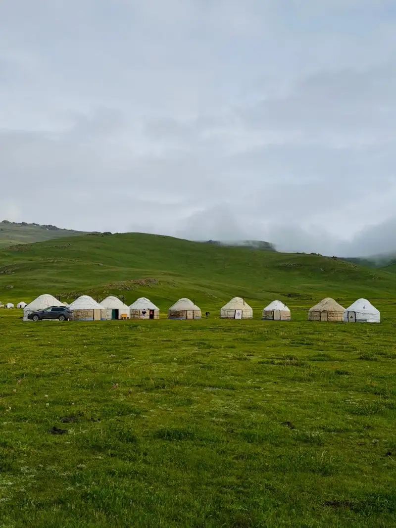 A family enjoying a meal inside a traditional yurt
