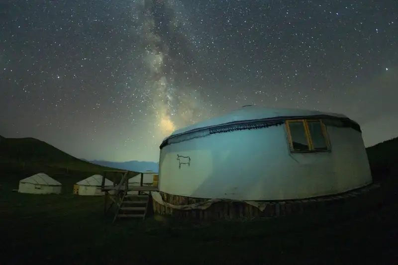 A Kyrgyz herder preparing tea in a yurt