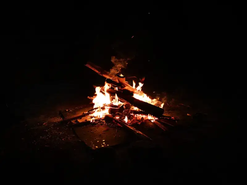 A Kyrgyz family gathered around a campfire under the stars