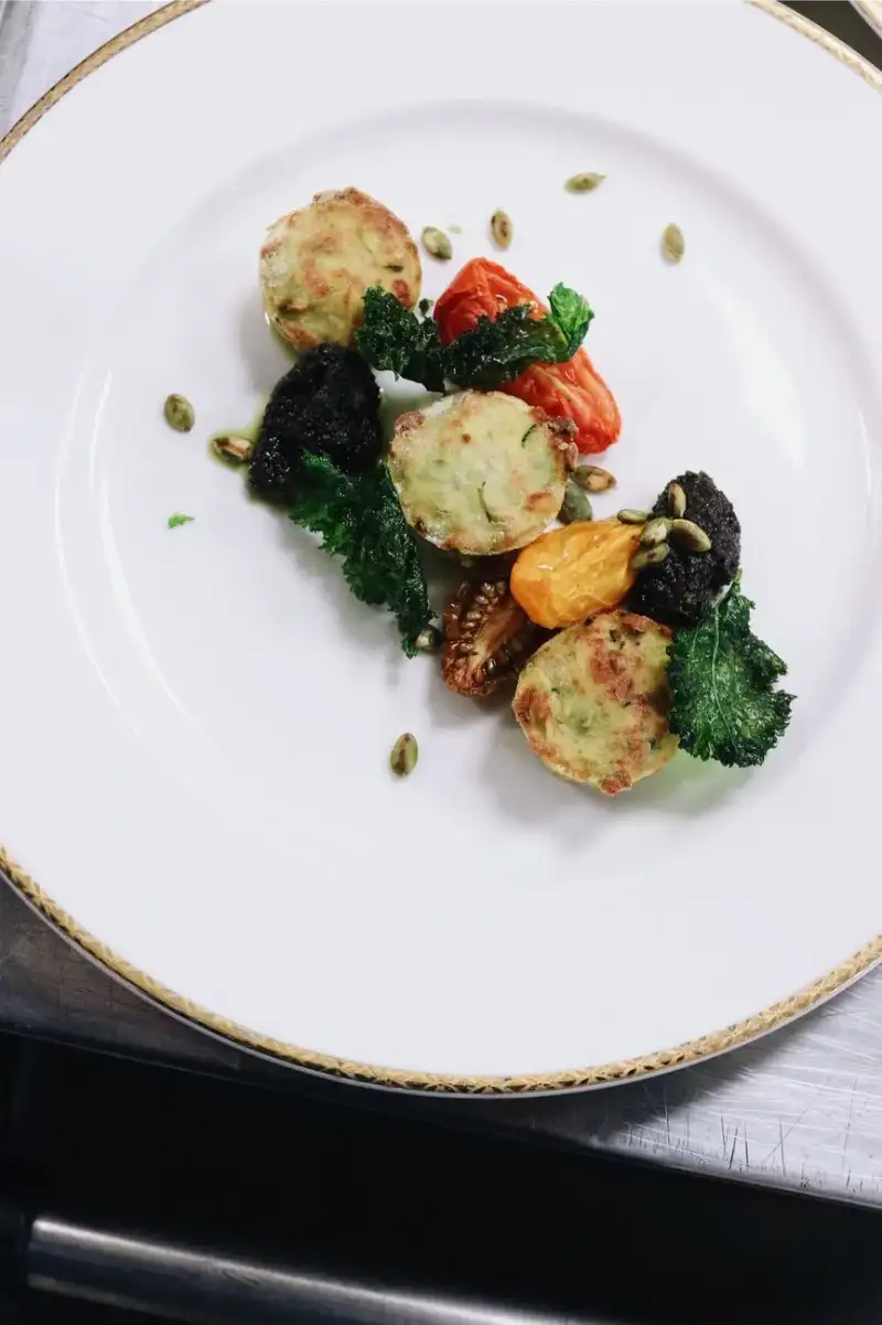 A beautifully plated vegetable dish with herbs