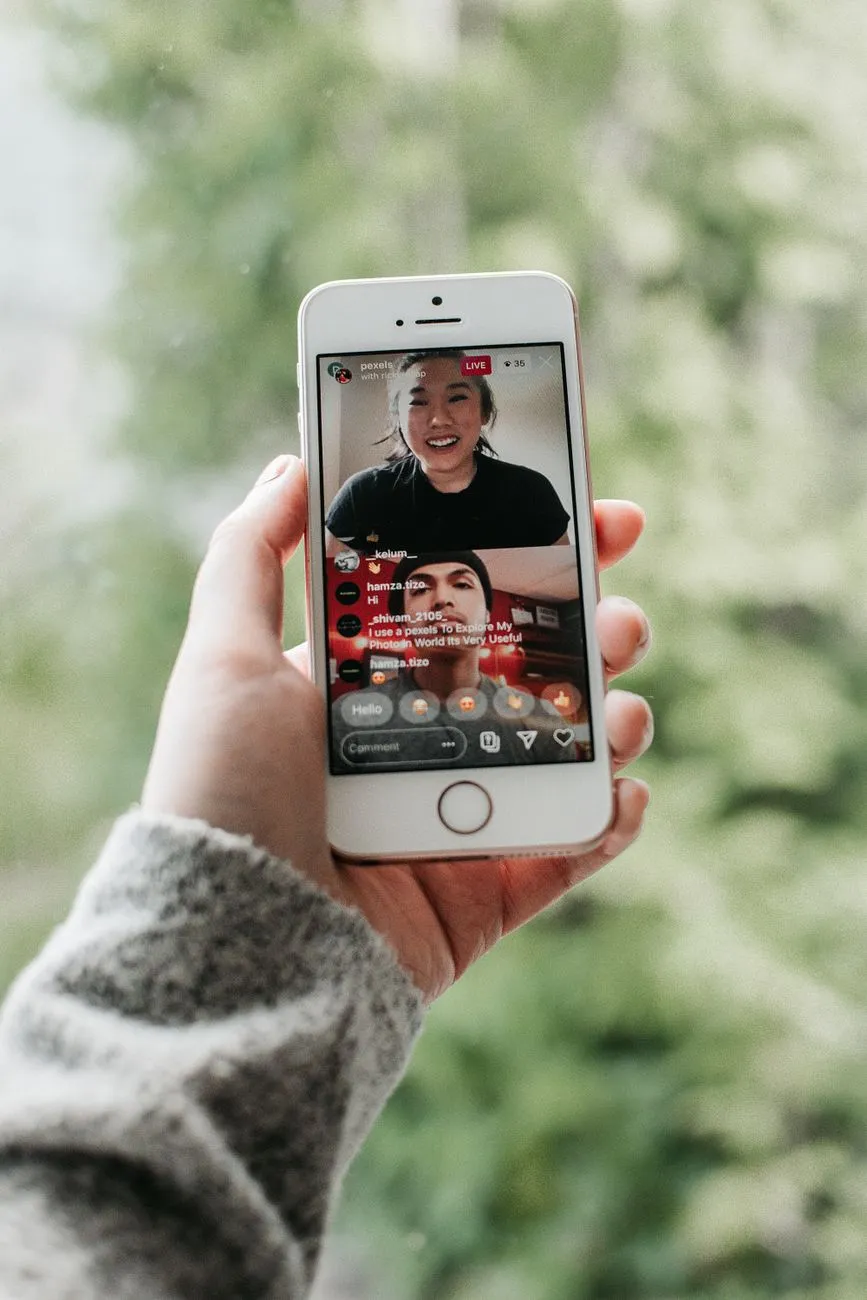 A person looking at a smartphone screen showing a distorted, AI-generated face