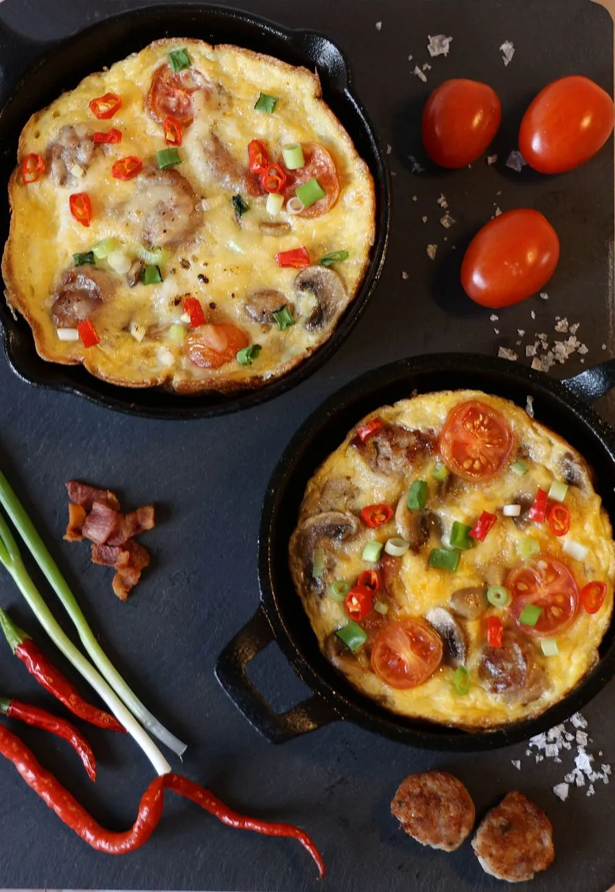 A golden Spanish tortilla being flipped in a skillet