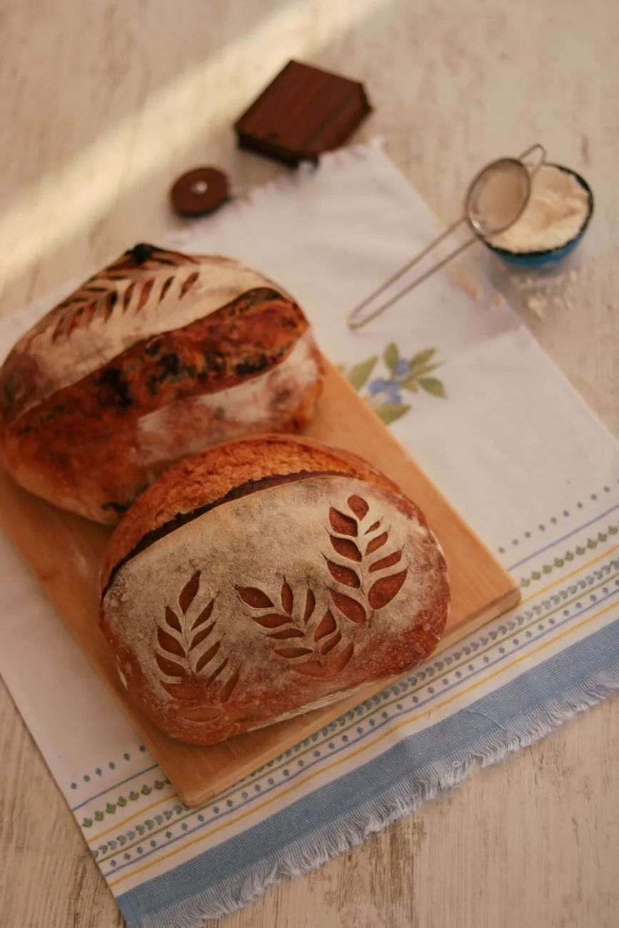 Artisan sourdough starter being fed in a jar
