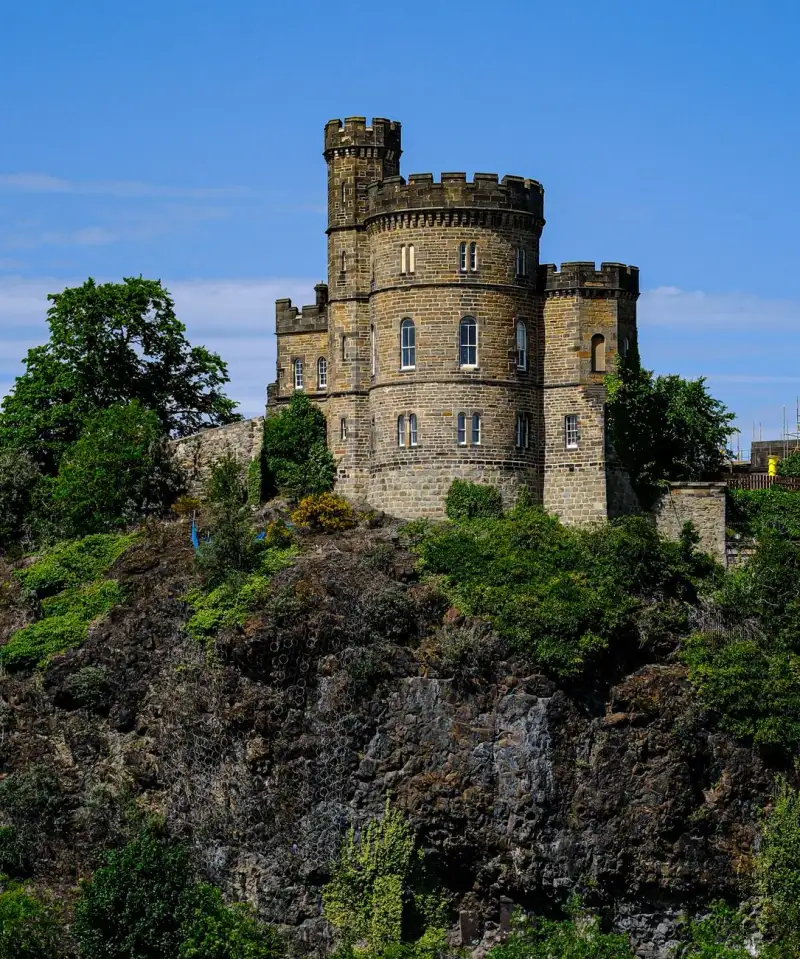 A traditional Highland castle with tartan flags flying