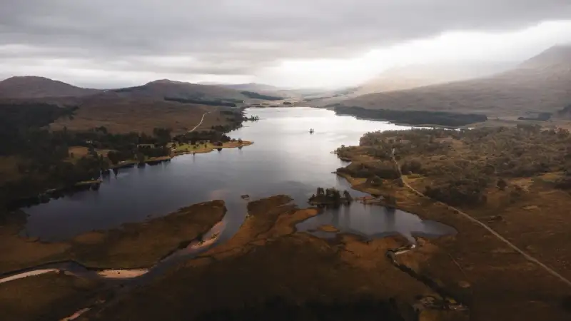 A cozy cabin with a view of a Highland loch
