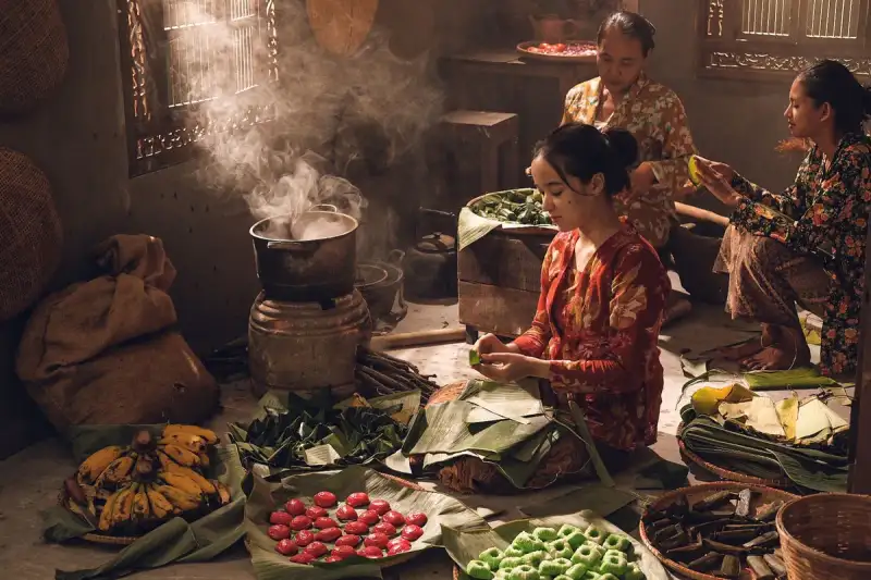 A group of people sharing a bowl of waakye
