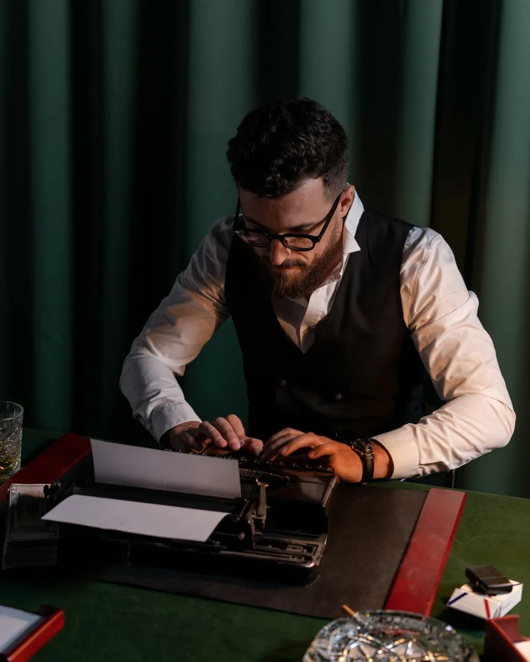 Author writing at desk with quill